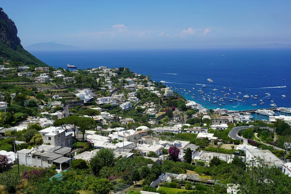 Coastal town with white buildings overlooking a blue sea