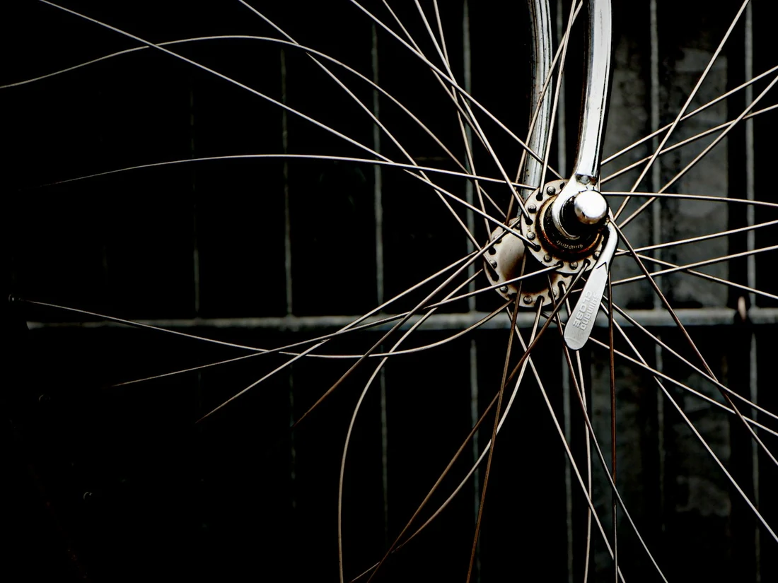 Wheel hub and spokes against a dark background