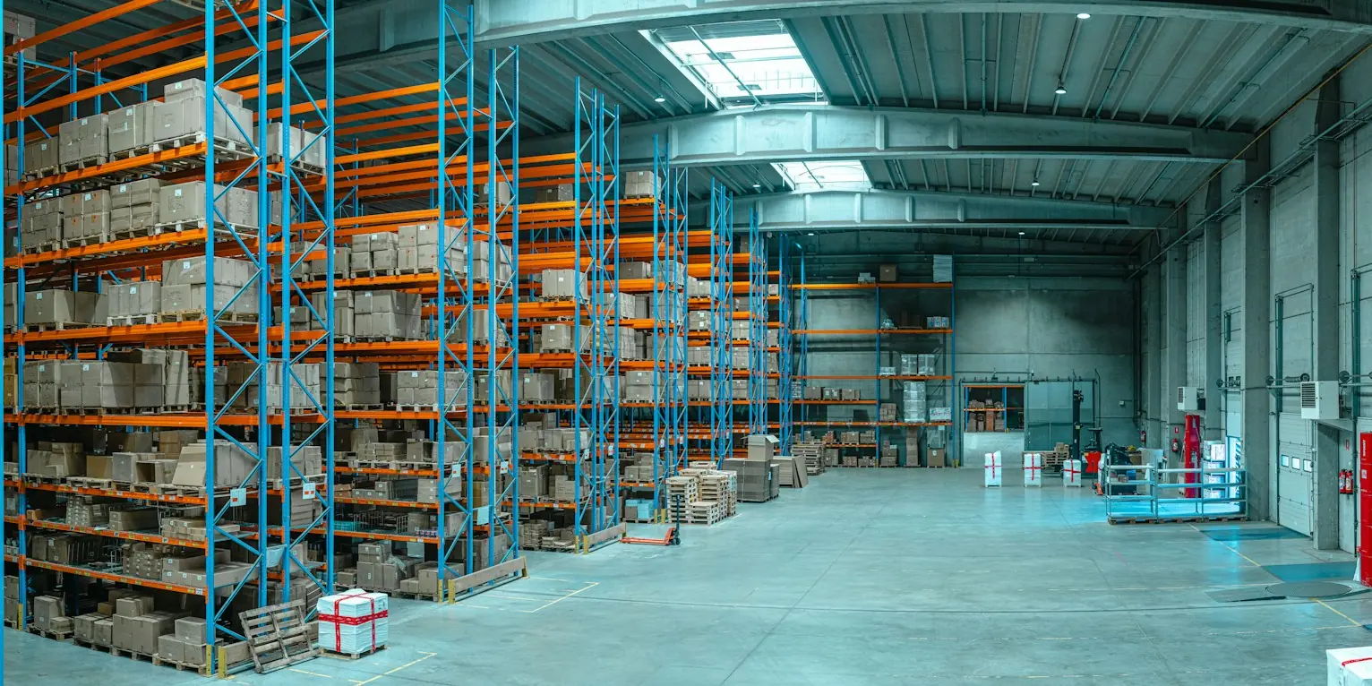 Warehouse aisle with blue and orange pallet racking